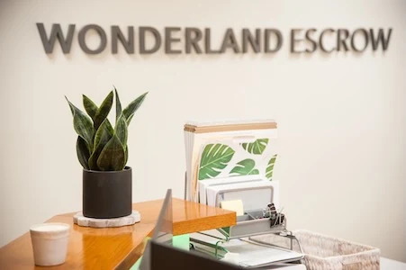 Wonderland Escrow lobby signage above the reception desk